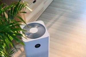 An air purifier on the wooden floor of a home