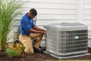 Air Hawk Heating And Cooling technician fixing a carrier air conditioning unit